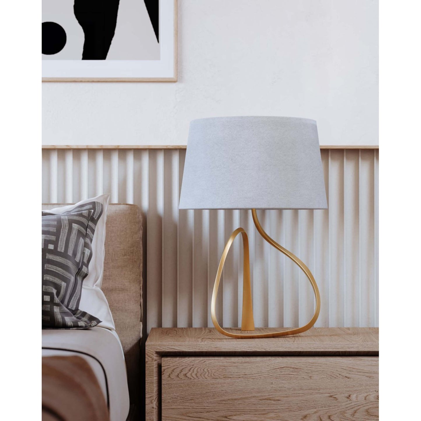 Ceramic table lamp with sculptural, flowing base and soft glow effect—elegant form that radiates ambient light and artistic charm
