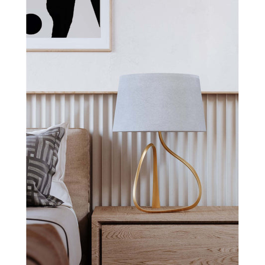 Ceramic table lamp with sculptural, flowing base and soft glow effect—elegant form that radiates ambient light and artistic charm